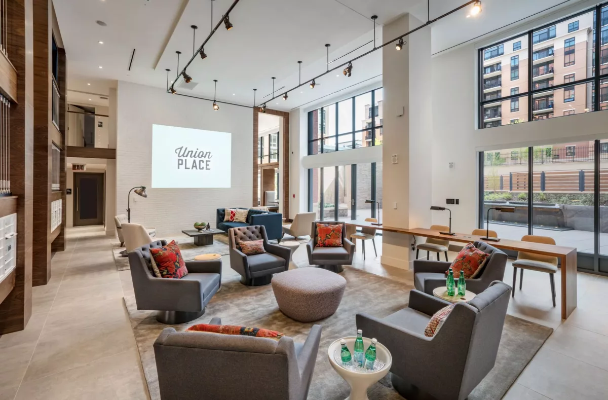 Community lounge with mixed seating, artwork, and open floor plan.