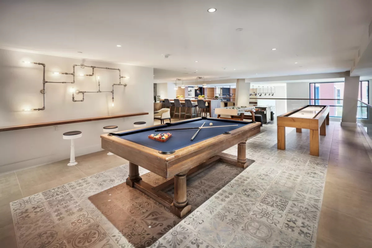 Game room with pool table, seating, and contemporary décor.