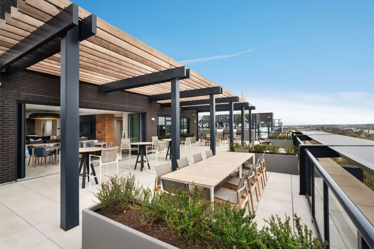Outdoor patio with seating, grill area, and landscaped surroundings.