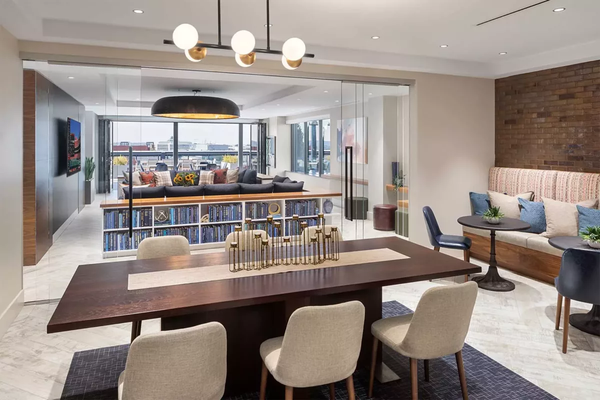 Resident lounge with bar seating, shelving, and modern lighting.